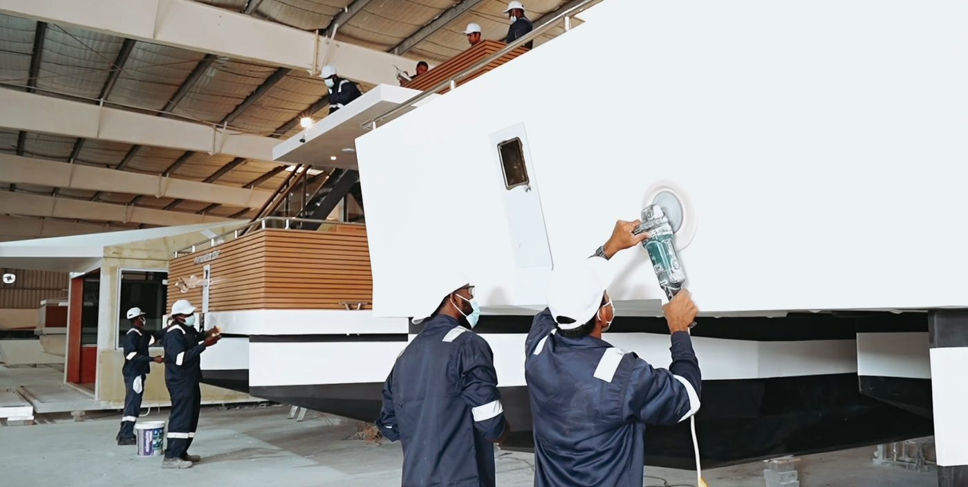 V-Marine technicians polishing a RISE hull inside the Bahrain factory