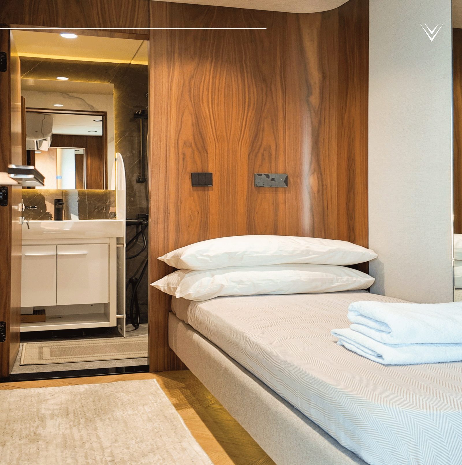 Crew cabin with berth, vanity and mirrored wardrobe