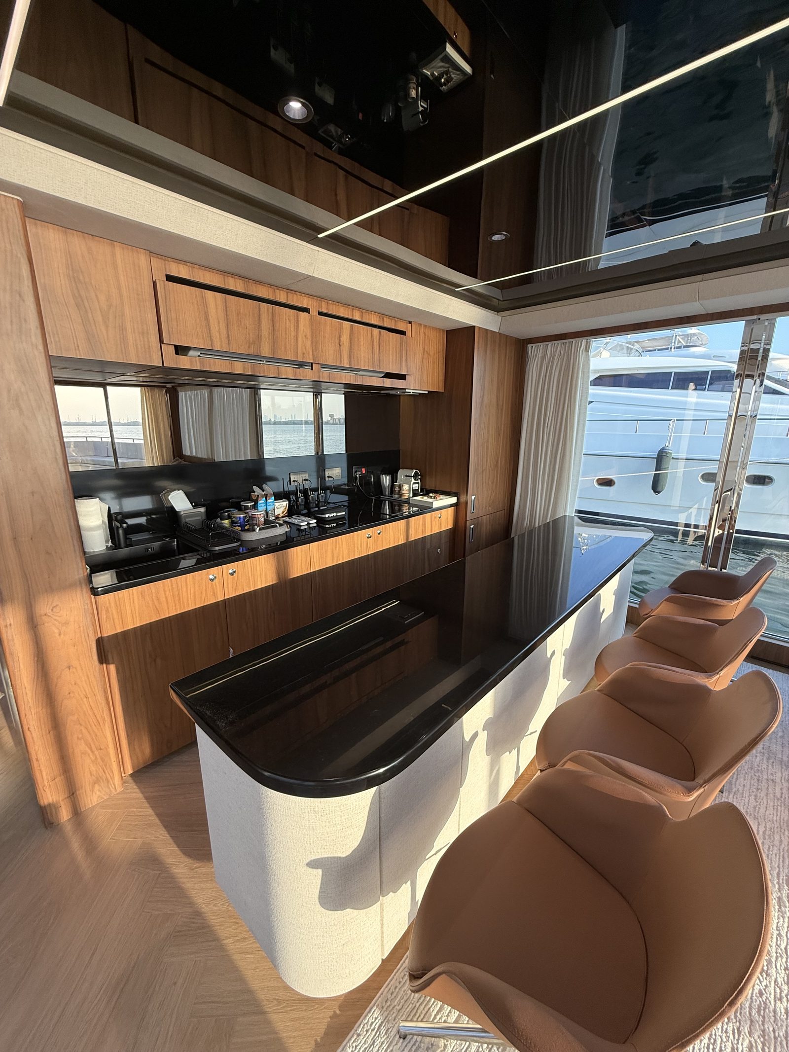 Galley with timber joinery, black countertops and sea views