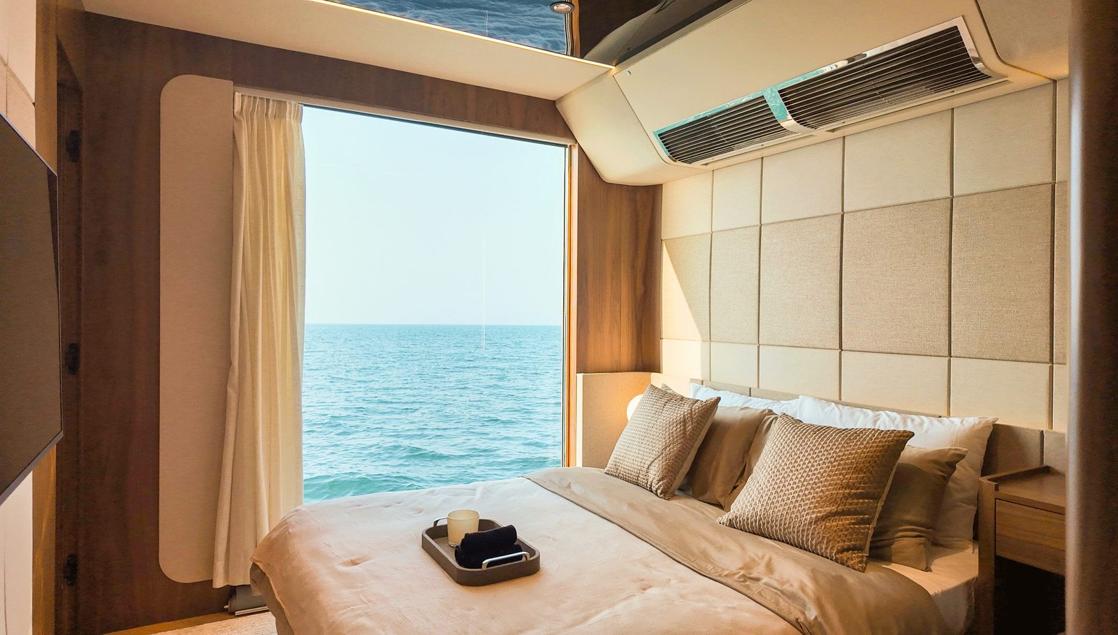 Master suite with queen bed facing a panoramic sea window